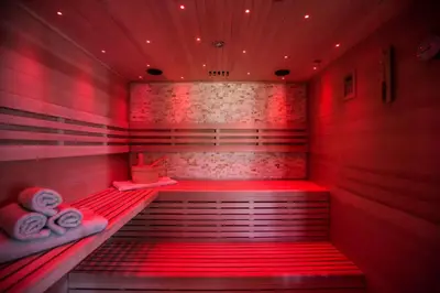 a sauna with red lights in a room at Zambelis Athens Penthouse Spa in Athens