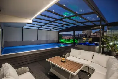 a living room with a pool and a couch and a table at Zambelis Athens Penthouse Spa in Athens