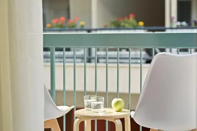 two chairs and a table with glasses and an apple on it at Luxurious Spacious Apt next to Hilton Hotel in Athens