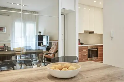 a kitchen and dining room with a bowl of food on a table at Modern Elegant Apt at Kolonaki in Athens
