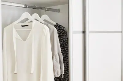 a white shirt and a tie hanging on a rack at Modern Elegant Apt at Kolonaki in Athens
