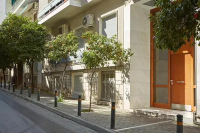a street with trees in front of a building at Modern Elegant Apt at Kolonaki in Athens