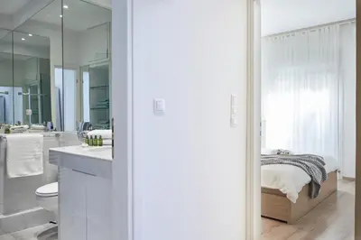 a bathroom with a sink and a toilet and a shower at Modern Elegant Apt at Kolonaki in Athens