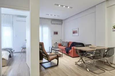 a living room with a couch and a table at Modern Elegant Apt at Kolonaki in Athens