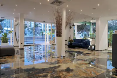 a lobby with a couch and a tree in it at Athenaeum Smart Hotel in Athens