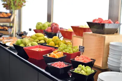 a buffet of fruits and vegetables on a counter at Athenaeum Smart Hotel in Athens
