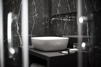 a bathroom with a bowl sink on a table at Athenaeum Smart Hotel in Athens
