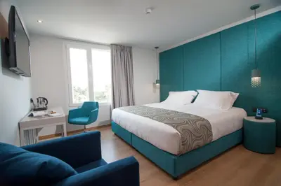 a hotel room with a bed and a chair at Athenaeum Smart Hotel in Athens