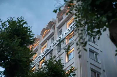 a building with a sign on the side of it at Athenaeum Smart Hotel in Athens