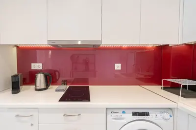 a kitchen with red walls and a stove top oven at Sophisticated Modern Apt in Athens center in Athens