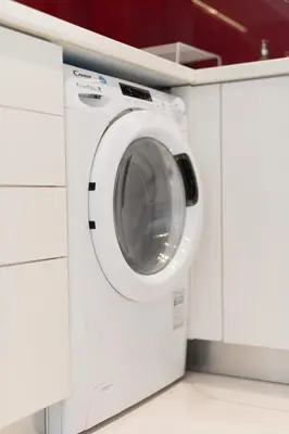 a white washing machine in a white laundry room at Sophisticated Modern Apt in Athens center in Athens
