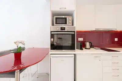 a kitchen with a counter with a microwave and a table at Sophisticated Modern Apt in Athens center in Athens