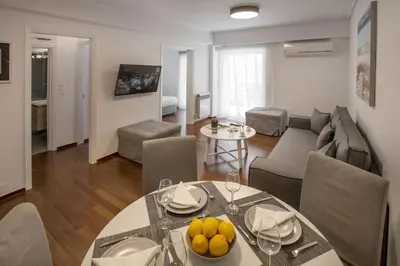 a living room with a dining table and a living room at Charming Apartment few steps from Acropolis by GHH in Athens