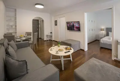 a living room with a couch and a table at Charming Apartment few steps from Acropolis by GHH in Athens