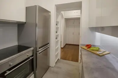 a kitchen with a stainless steel refrigerator at Charming Apartment few steps from Acropolis by GHH in Athens