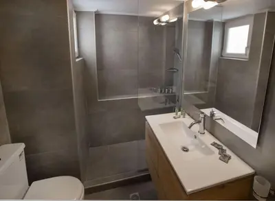 a bathroom with a sink and a toilet and a mirror at Charming Apartment few steps from Acropolis by GHH in Athens