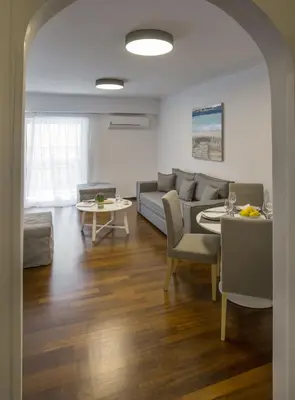 a living room with a couch and a table at Charming Apartment few steps from Acropolis by GHH in Athens