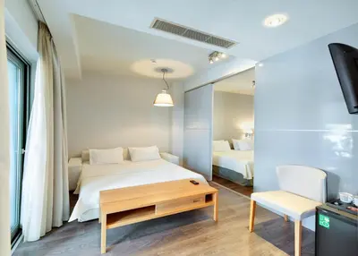 a bedroom with a bed and a table and a mirror at Phidias Piraeus Hotel in Piraeus