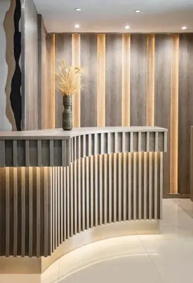 a bench in a lobby with a vase on the wall at Phidias Piraeus Hotel in Piraeus