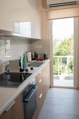 a kitchen with a sink and a stove top oven at AT.thea ATHENS BOUTIQUE APARTMENTS in Athens