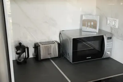 a microwave sitting on a counter next to a toaster at AT.thea ATHENS BOUTIQUE APARTMENTS in Athens