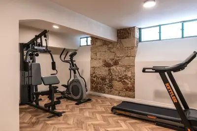 a gym with two treadmills and two exercise bikes at Athens One Smart Hotel in Athens