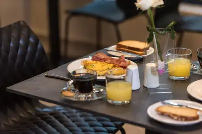 a table topped with breakfast foods and orange juice at Athens One Smart Hotel in Athens