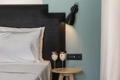 a bedroom with a bed and a table with two vases at Athens One Smart Hotel in Athens