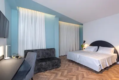 a bedroom with a bed and a couch at Athens One Smart Hotel in Athens