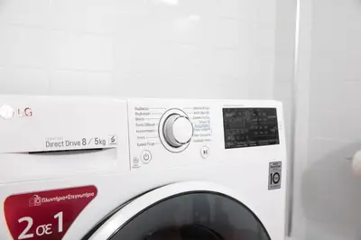 a white washing machine with a sign on it at Metro Fix Cosy Apartment in Athens