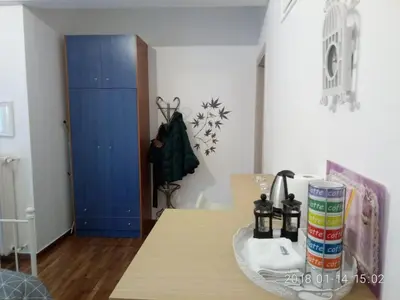a room with a table and a blue door at Modern, ideally located studio apartment in Athens