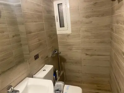 a bathroom with a toilet and a sink at Modern, ideally located studio apartment in Athens