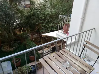 a wooden bench sitting on top of a balcony at Modern, ideally located studio apartment in Athens