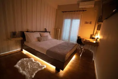 a bedroom with a bed and a desk and a window at COZY APT NEXT TO METRO AND CLOSE TO ACROPOLIS! in Athens