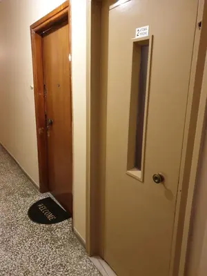 a hallway with a door and a mirror on the floor at COZY APT NEXT TO METRO AND CLOSE TO ACROPOLIS! in Athens