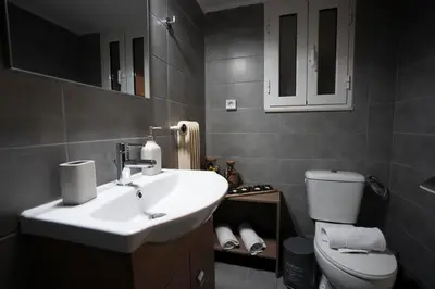 a bathroom with a sink and a toilet at COZY APT NEXT TO METRO AND CLOSE TO ACROPOLIS! in Athens