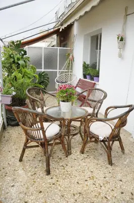 a patio table with four chairs and a table with flowers at Mosaics Central aprtm with Acropolis View ! in Athens