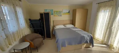 a bedroom with a bed and a chair in it at Sunny Elegant Studio in Athens
