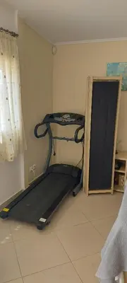 a room with a treadmill in the corner of a room at Sunny Elegant Studio in Athens