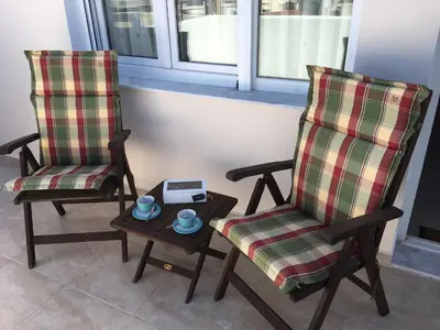 two chairs sitting next to a table with a scale at Sunny Elegant Studio in Athens