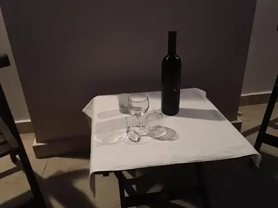 a bottle of wine sitting on a table with wine glasses at Sunny Elegant Studio in Athens
