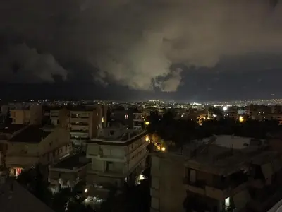 a view of a city at night with storm clouds at Sunny Elegant Studio in Athens