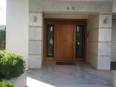 a building with a wooden door in a building at Sunny Elegant Studio in Athens