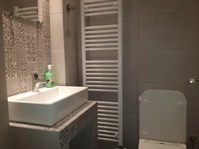 a bathroom with a sink and a toilet at Neoclassical House with Unique Athenian Yard (nearby metro station) in Athens