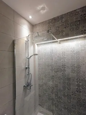 a shower with a glass door in a bathroom at Neoclassical House with Unique Athenian Yard (nearby metro station) in Athens