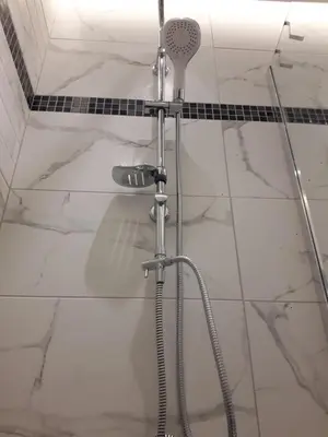 a shower in a bathroom with white marble tile at Neoclassical House with Unique Athenian Yard (nearby metro station) in Athens