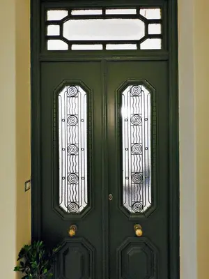 a green door with a window on top of it at Neoclassical House with Unique Athenian Yard (nearby metro station) in Athens