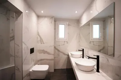 a white bathroom with two sinks and a toilet at Modern 2bed 2bath loft in Acropolis area in Athens