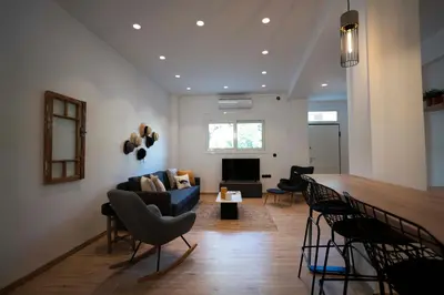 a living room with a blue couch and chairs at Modern 2bed 2bath loft in Acropolis area in Athens