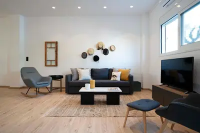 a living room with a couch and a tv at Modern 2bed 2bath loft in Acropolis area in Athens